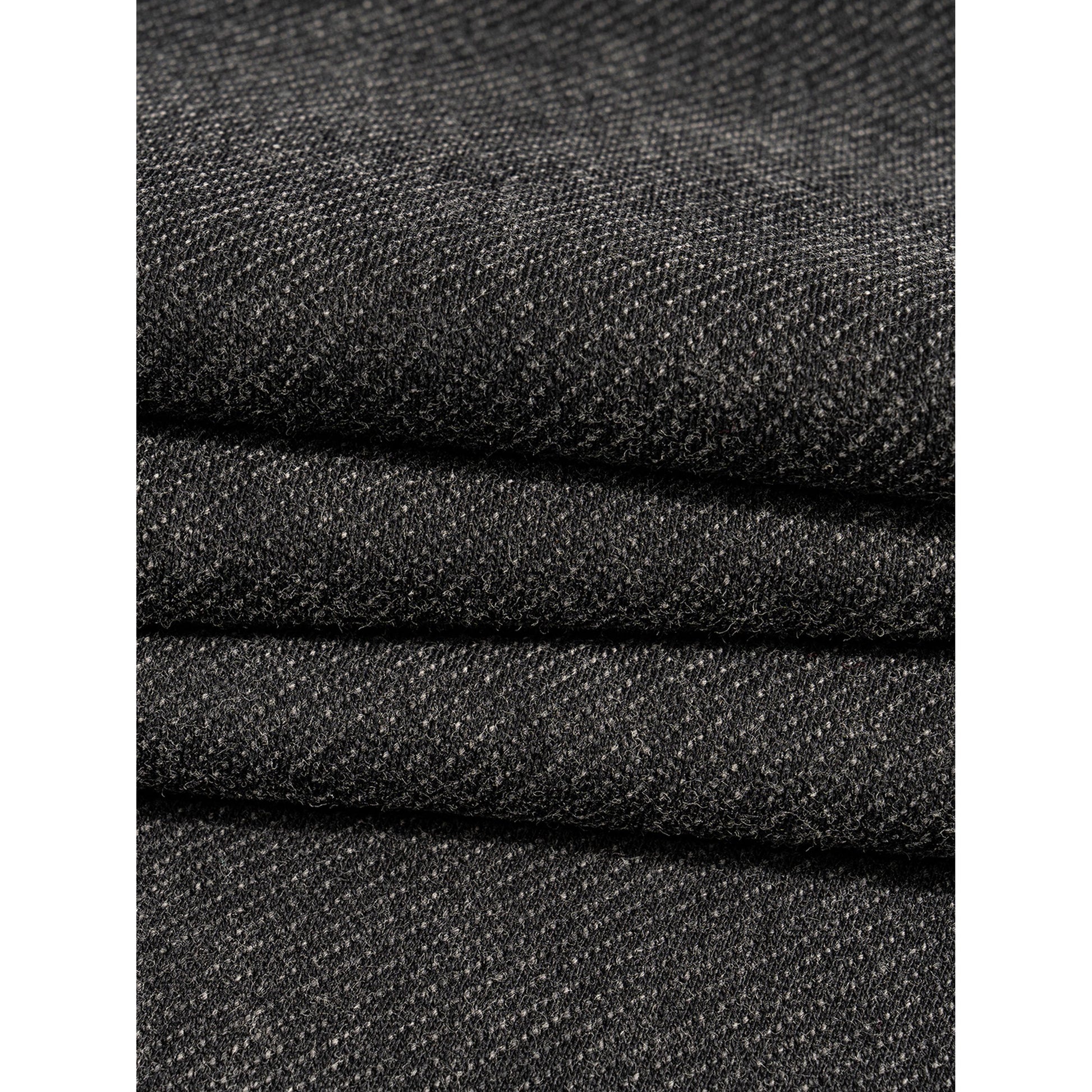 Close-up of stacked black fabric with a textured pattern