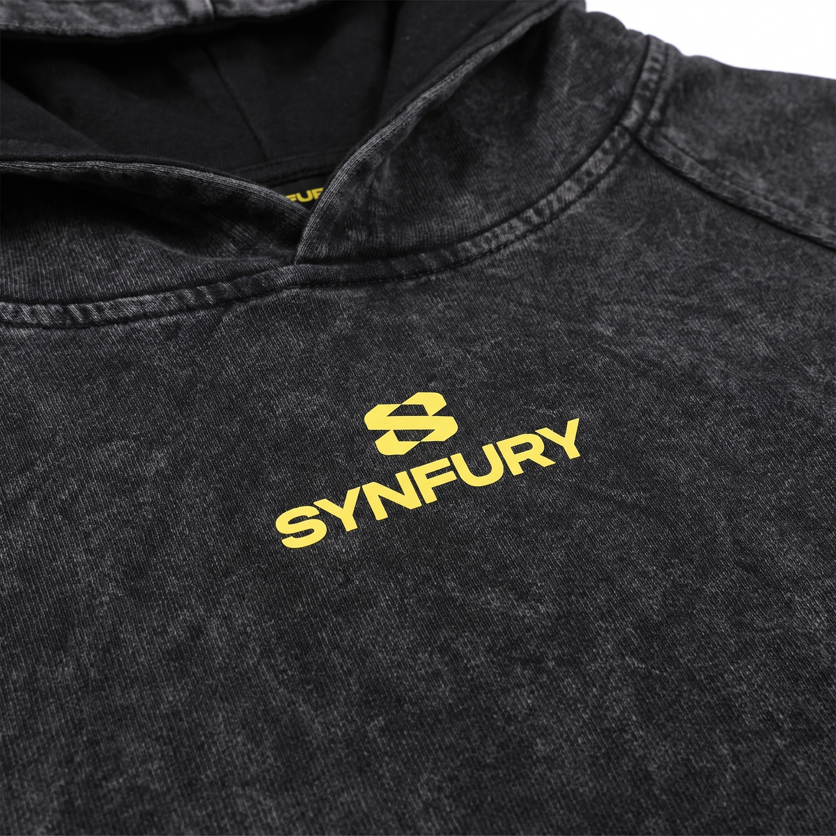 SYNFURY logo printed in gold on acid-washed black pullover hoodie