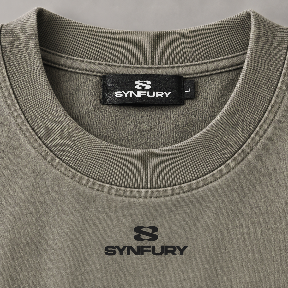 SYNFURY neck label and chest logo detail on oversized tee, Vintage Clay