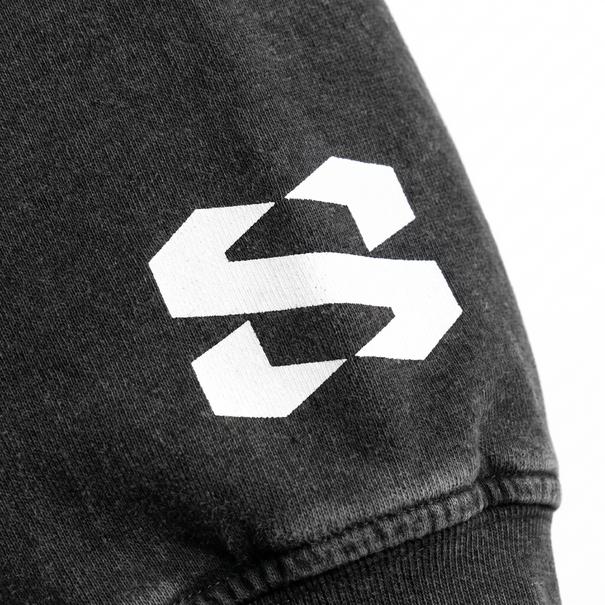 Close-up of sleeve with SYNFURY 'S' logo, heavyweight cotton fabric