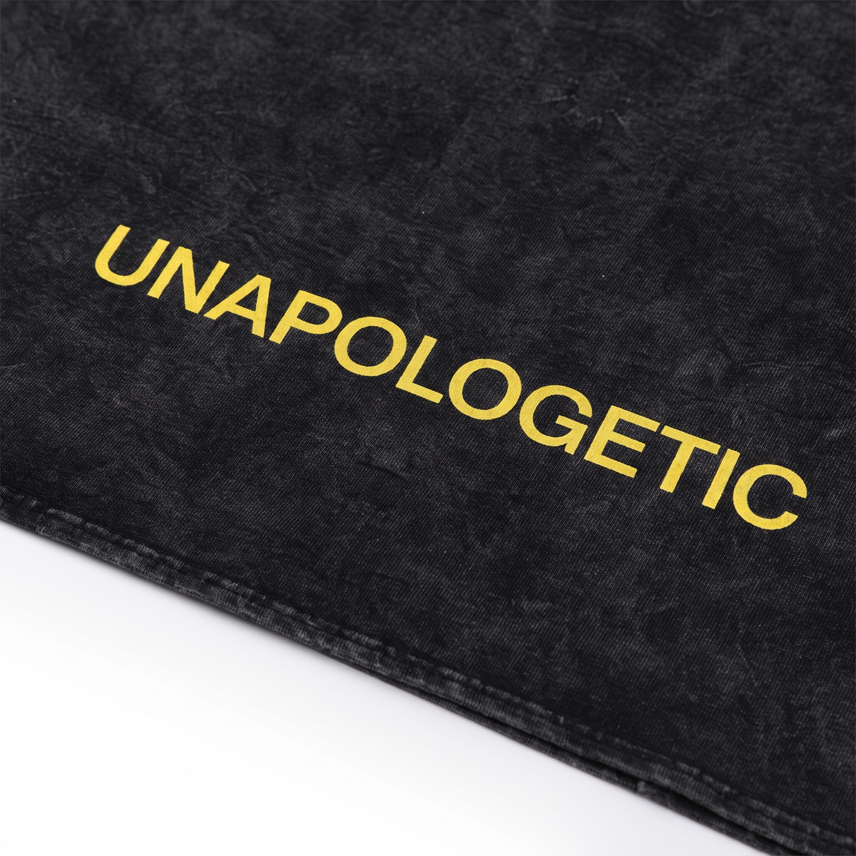 UNAPOLOGETIC" graphic print on SYNFURY washed black garment
