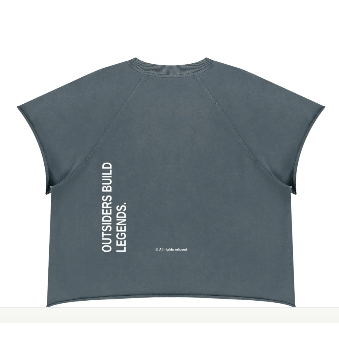 The back of SYNFURY'S dark slate gray cropped t-shirt with vertical white text reading 'OUTSIDERS BUILD LEGENDS.' and a small copyright line below it, displayed on a clean white background.