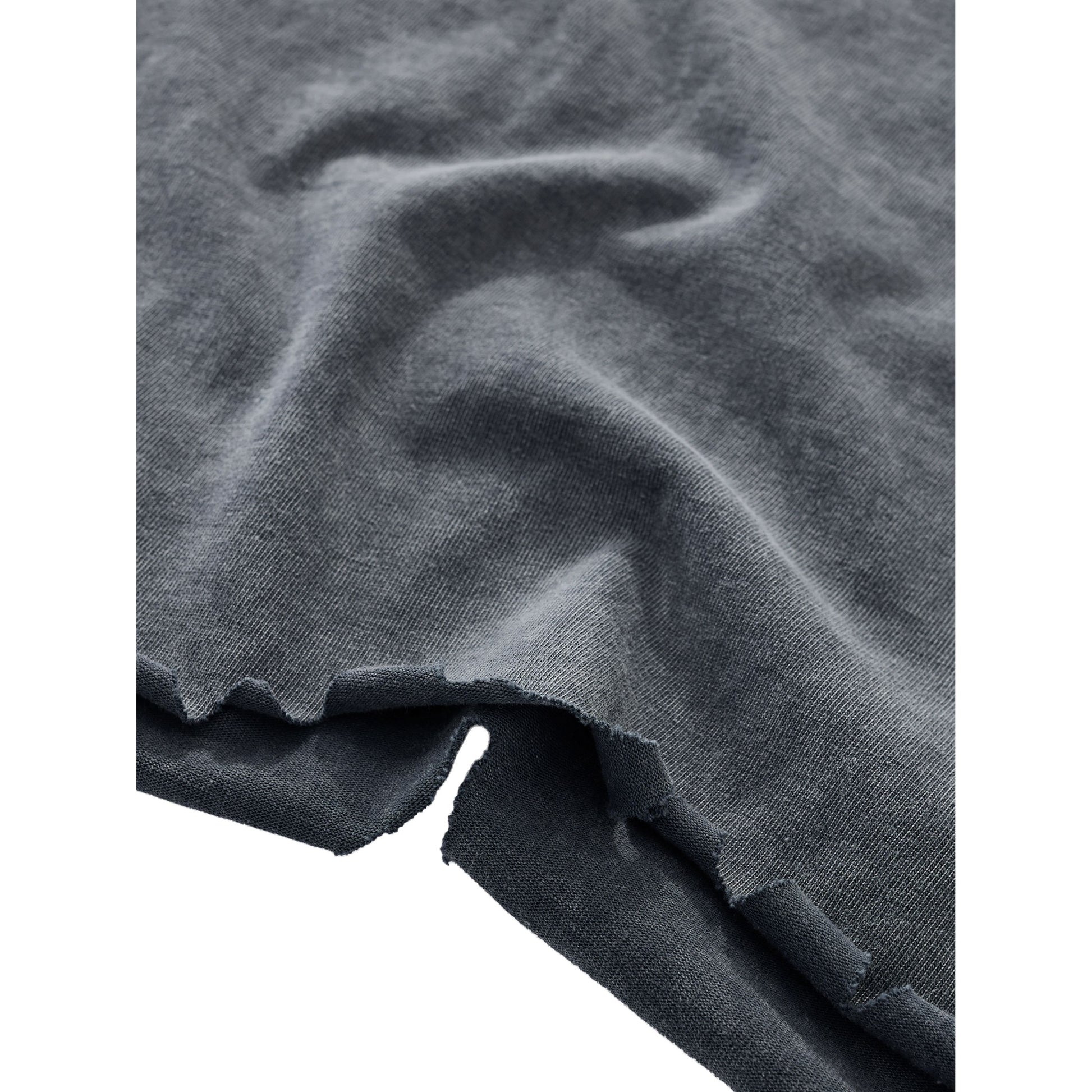 Close-up of dark gray fabric with folds on a white background