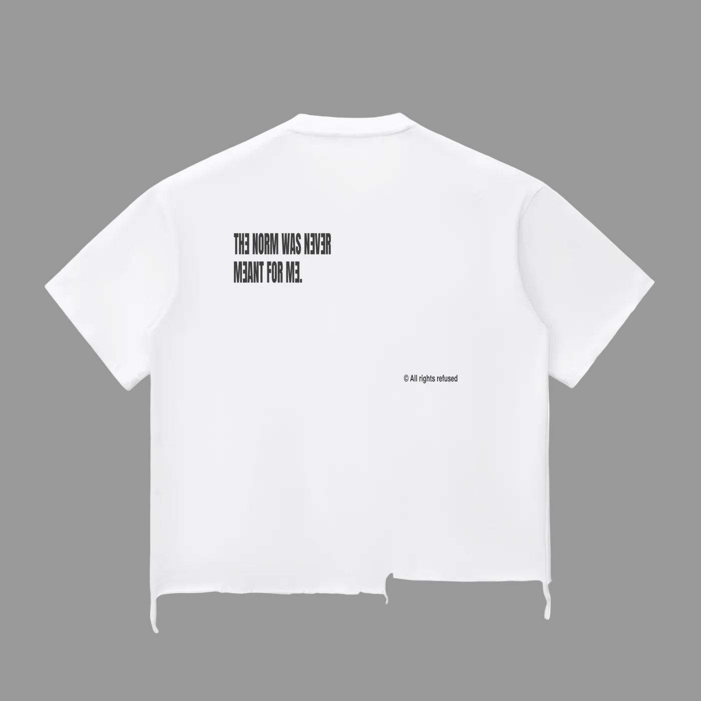 White short-sleeve cropped T-shirt shown from the back, featuring black printed text that reads 'THE NORM WAS NEVER MEANT FOR ME.' with a small '© All rights reserved' line below, on a plain white background.